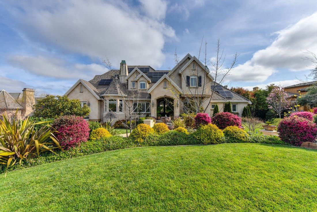 Front yard with layered flower beds and a curved lawn edge