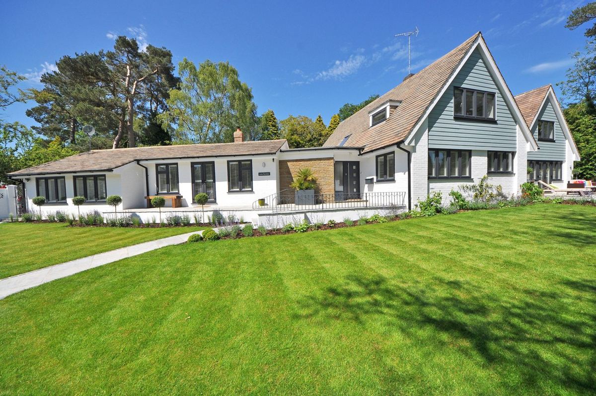 Freshly striped lawn in front of a white two-story home