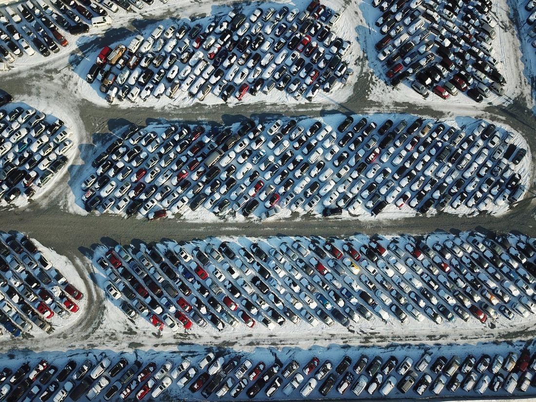 Aerial view of a snow-covered commercial parking lot